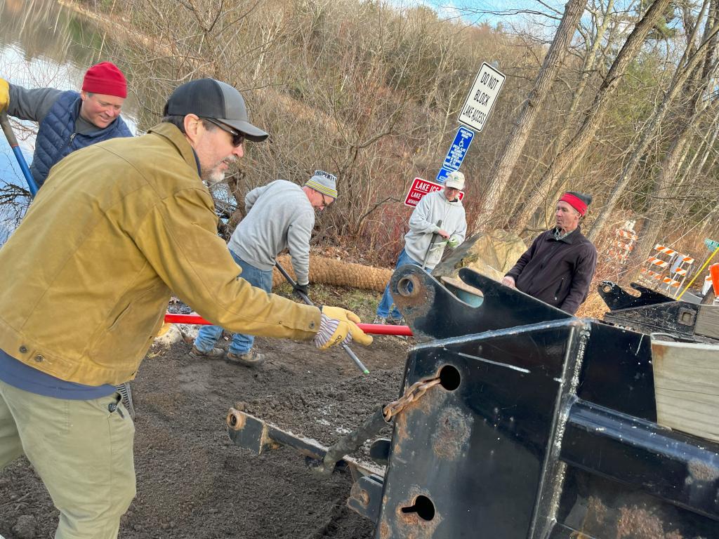 The volunteer squad made quick work of installing coir logs to retain new soil, new soil was raked into place. . .