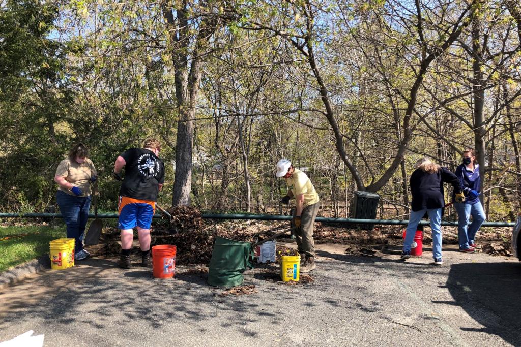 Industrious boy scouts and their leaders make short work of cleaning up the St. Peter's parkin lot area.